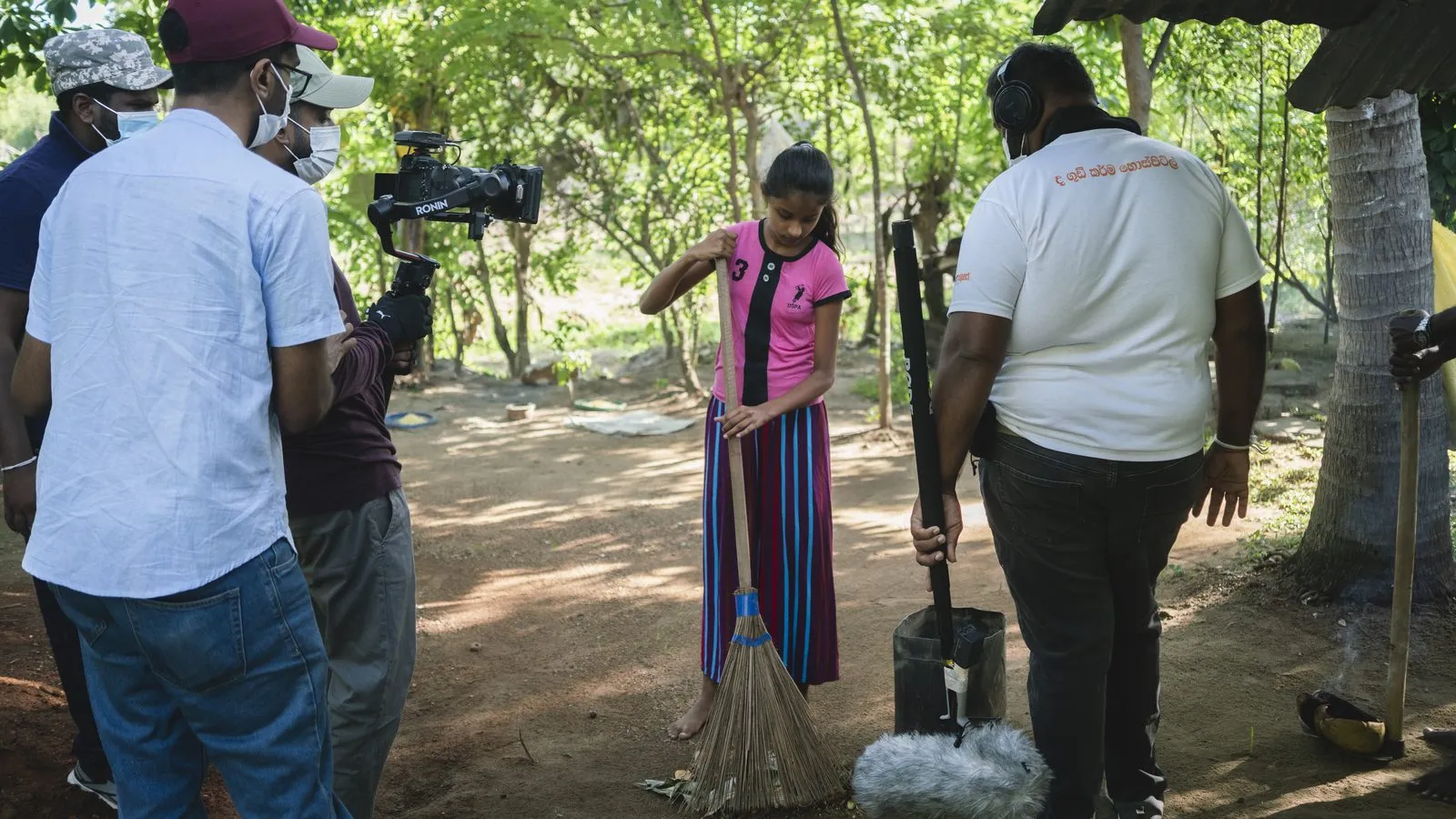 Camera and boom crew with a subject on a forest path in Sri Lanka