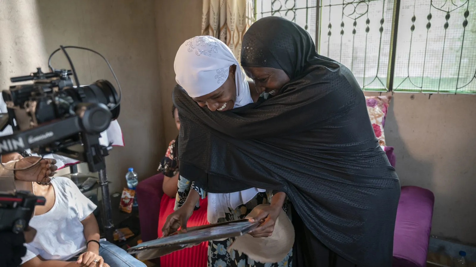 Camera and boom crew filming two women indoors in Tanzania