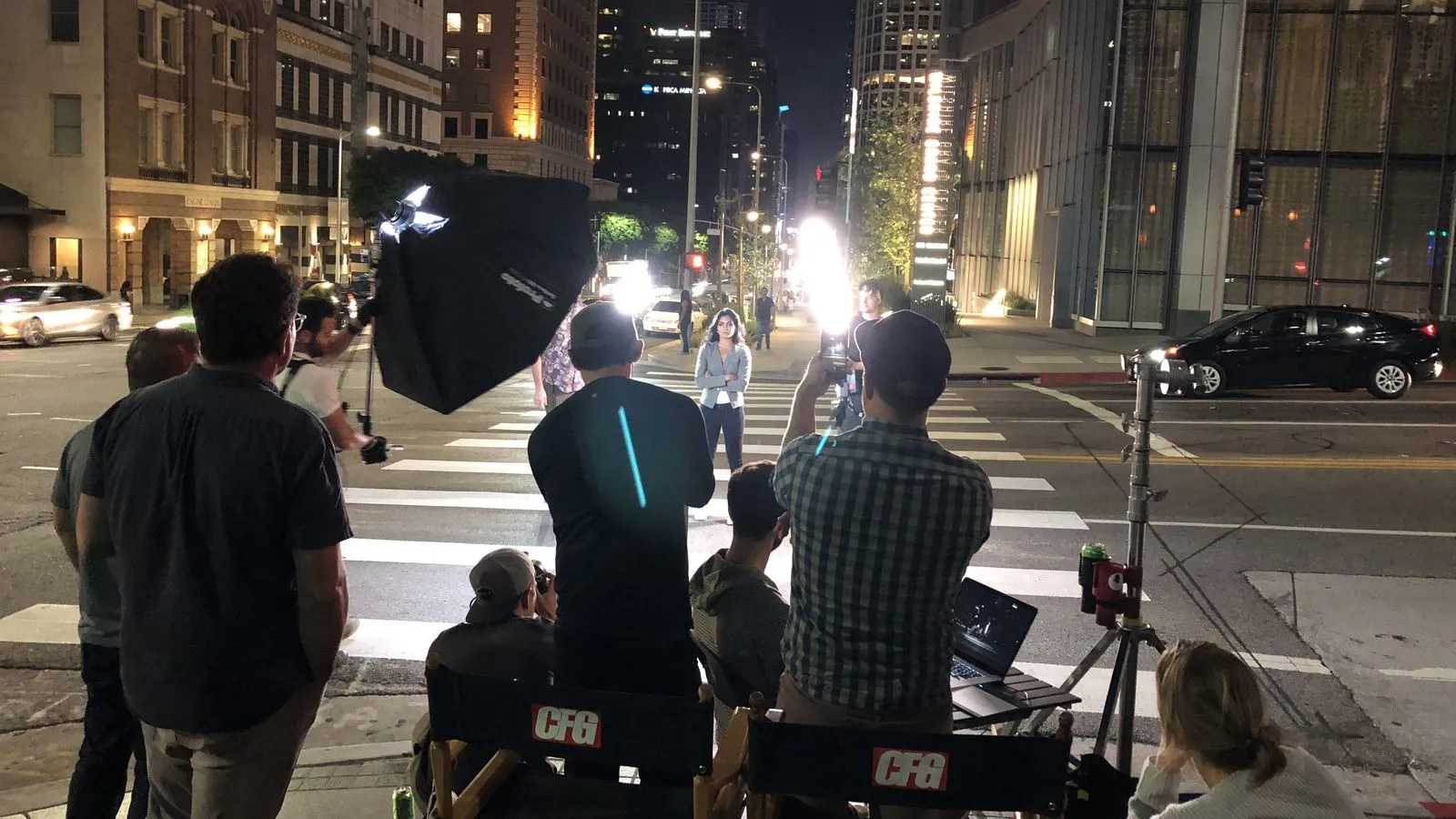 A Moonshine night shoot on a city street, crew and lights around the camera